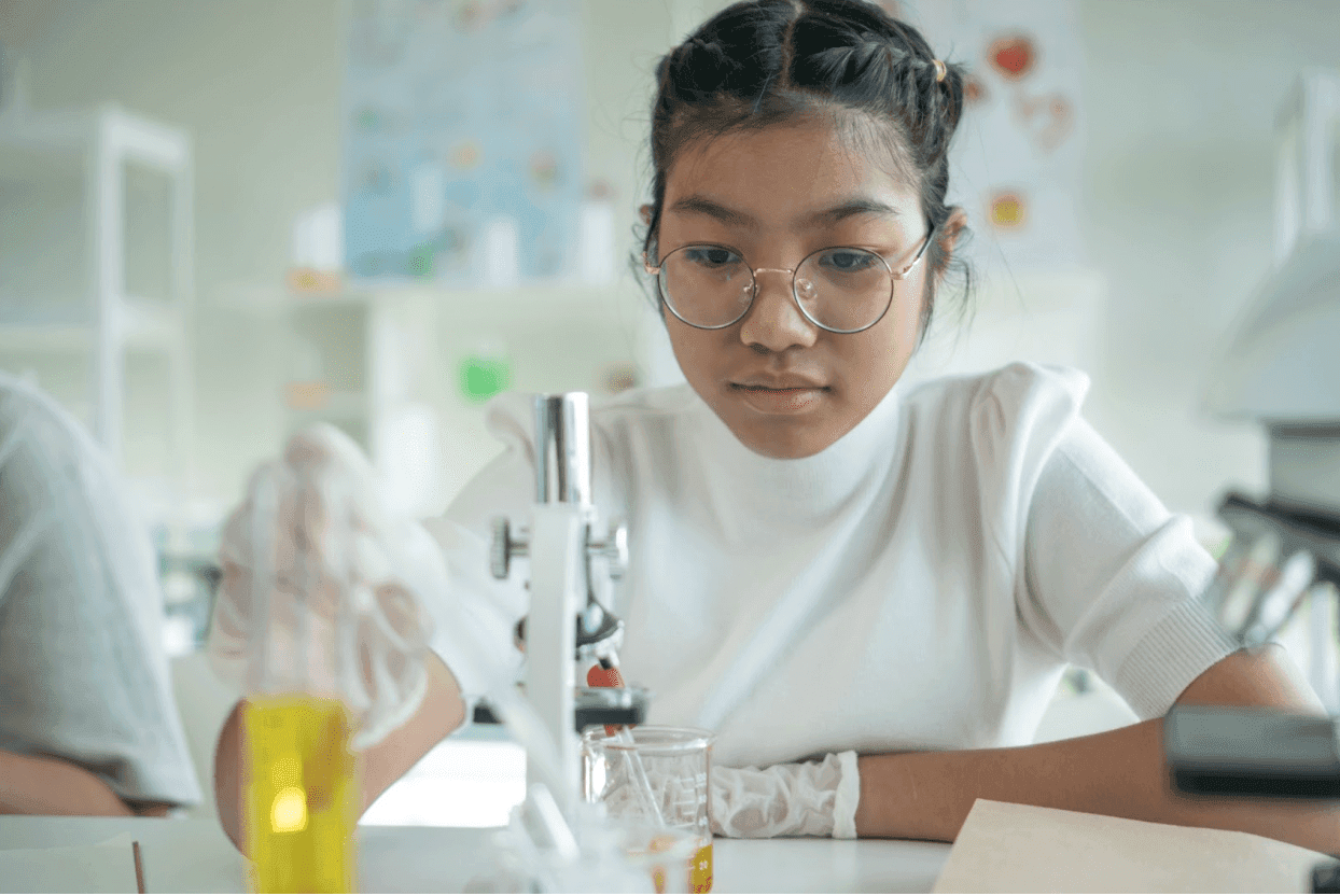 A student focuses on a a project based learning task in her high school lab.