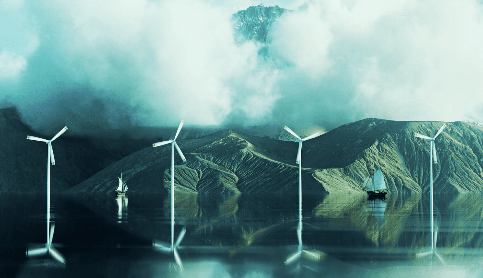 Image of wind turbines in a body of water with sailboats and mountains in the background