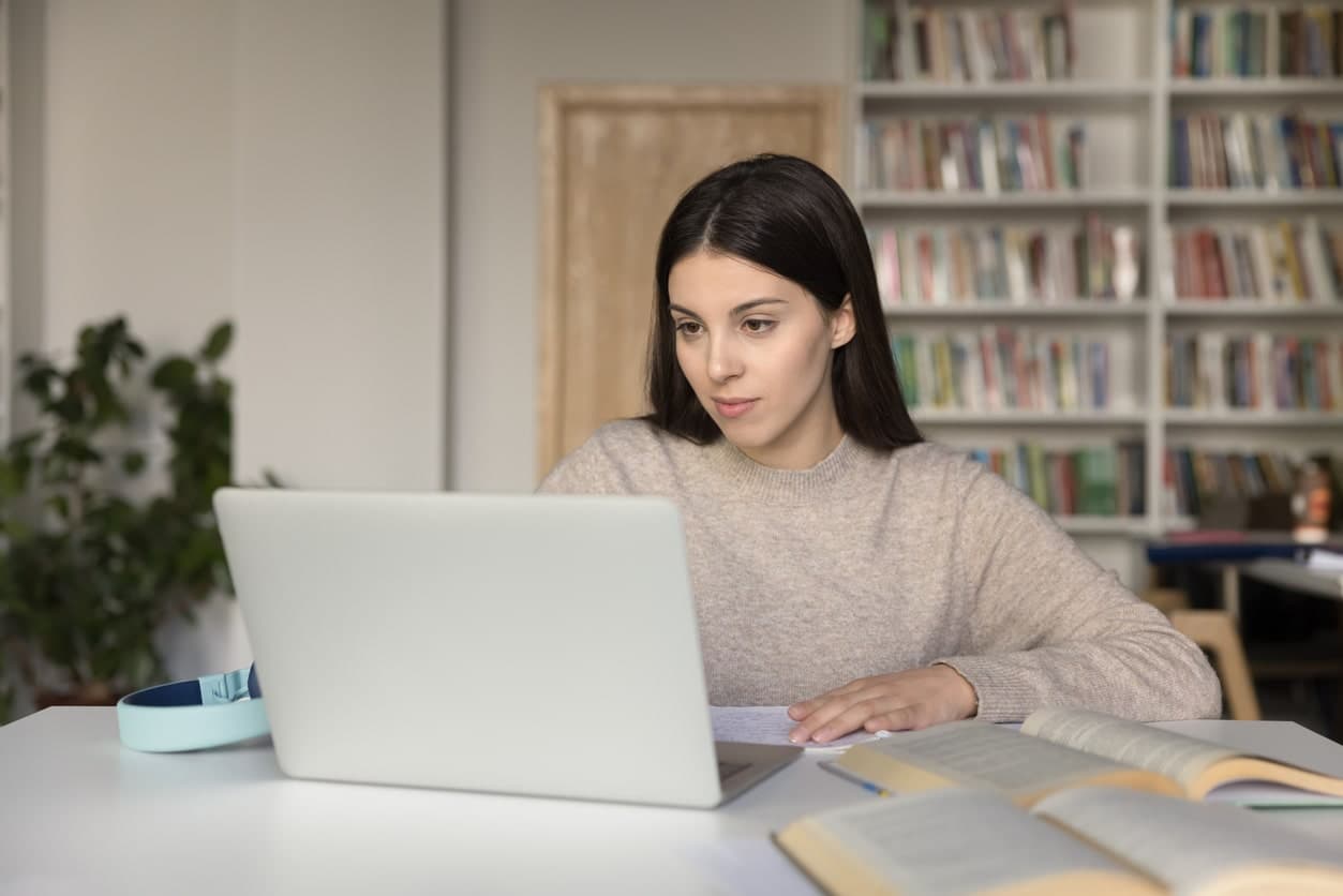 A student types an admissions appeal letter from her laptop.