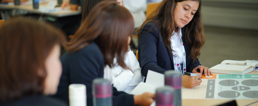 High school students in professional attire collaborate during a hands-on workshop, capturing their curiosity and leadership at the heart of our blog stories.