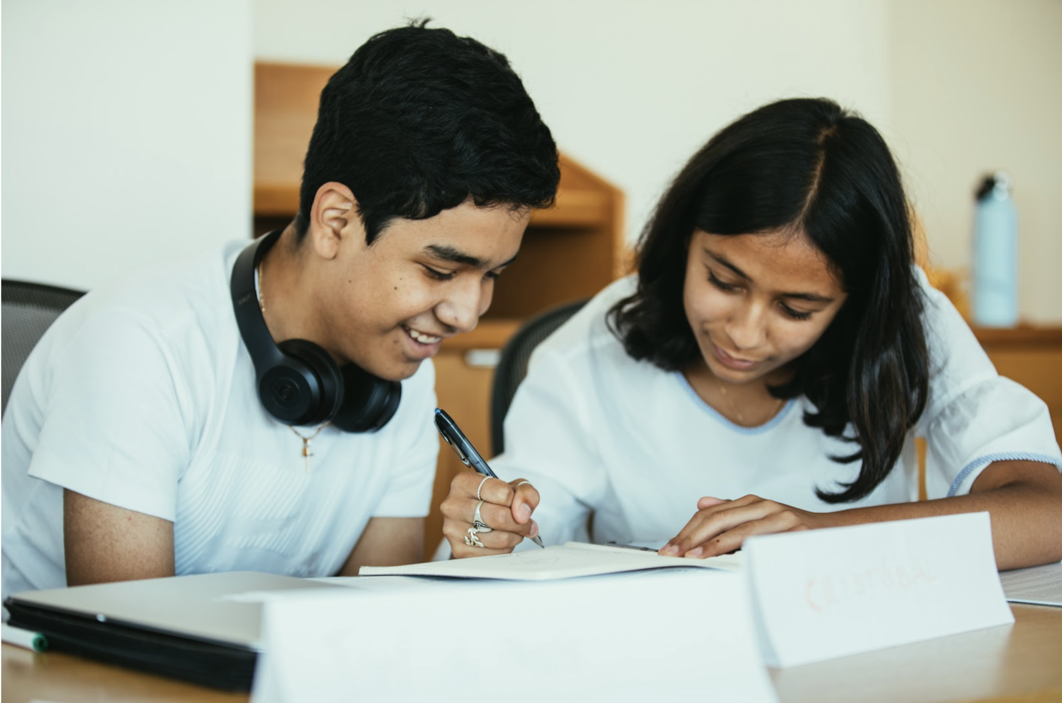 Students working on their college essay together.