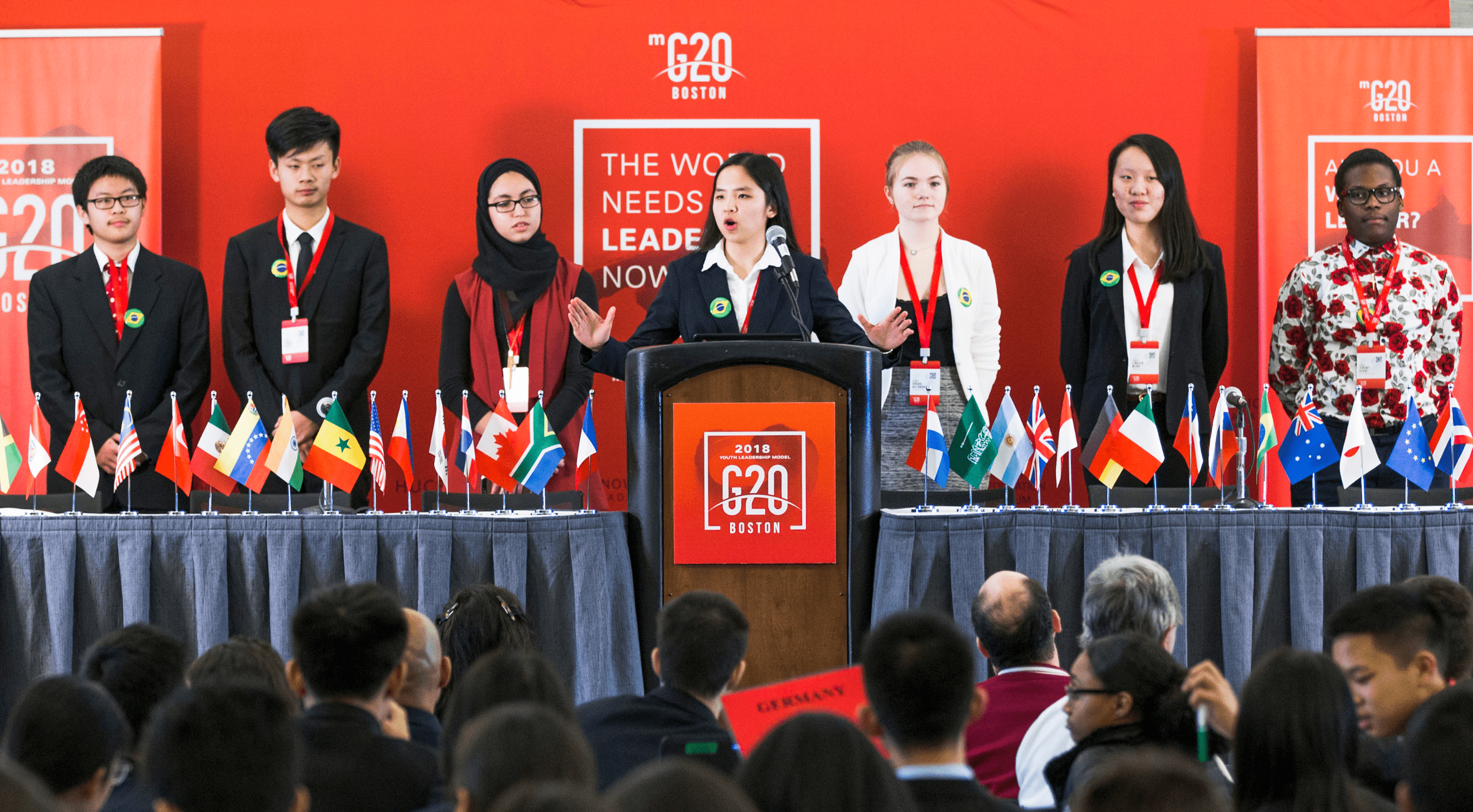 A group of passionate delegates is presenting in front of the crowd at the Model G20 Global Leadership program.